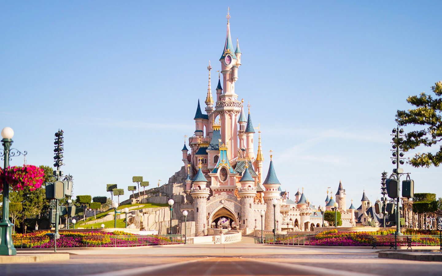 Sleeping Beauty Castle at Disneyland Paris with vibrant colors and clear blue sky