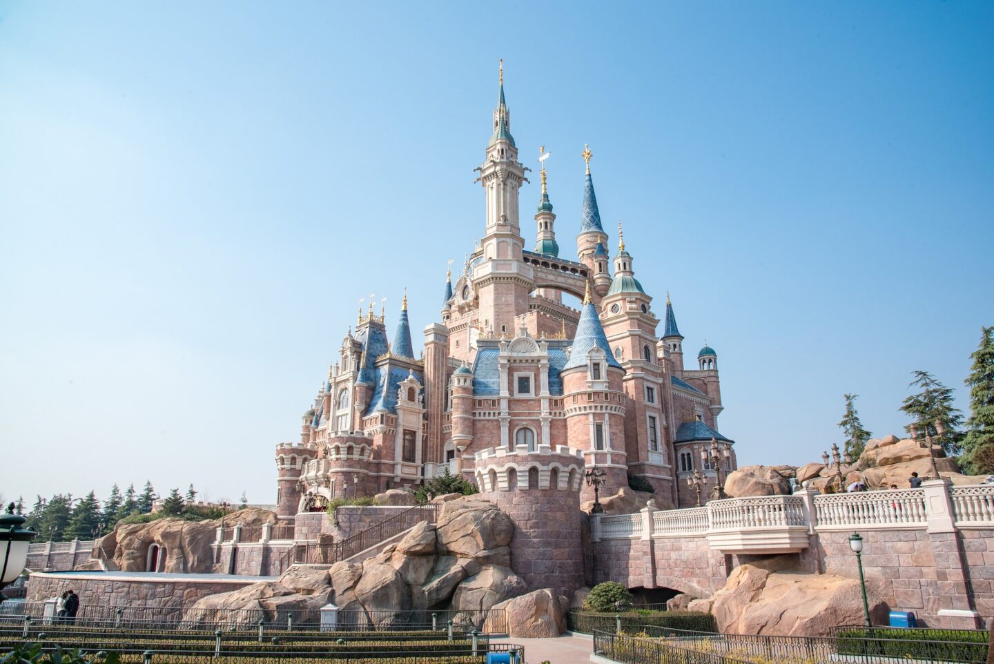 Enchanted Storybook Castle at Shanghai Disneyland with its grand architecture and clear blue sky